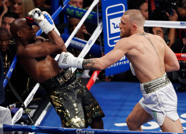 Conor McGregor pressures Floyd Mayweather with jabs during a Super Welterweight fight on Aug. 26.
