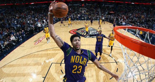 Flying High:  Anthony Davis rattles the rim with a bone-crunching dunk for the New Orleans Pelicans.