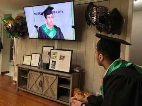 Mohammad Samra watching himself in his pre-recorded graduation speech during Roosevelt Universitys virtual graduation ceremony in May 2021.