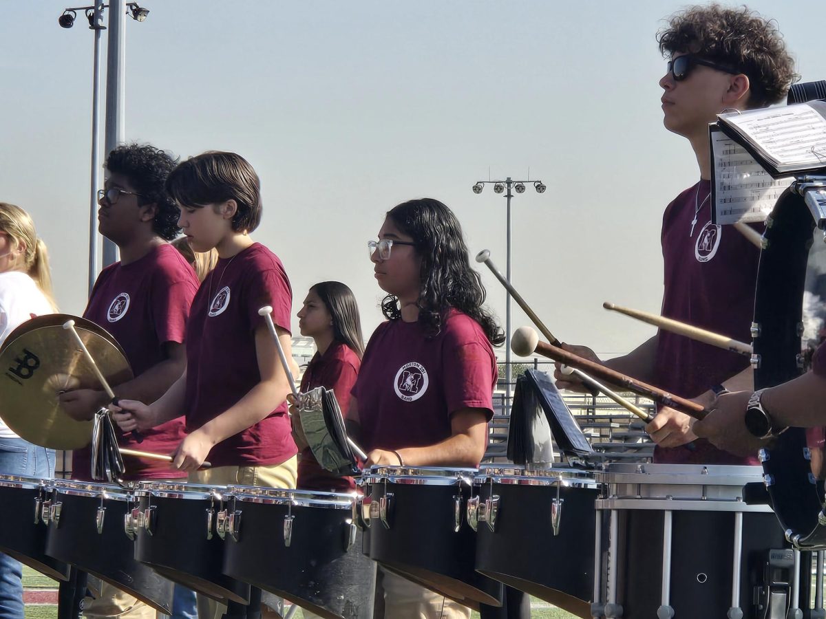 Members of the Mustang marching band drumline roll through their cadence at the all-school assembly on Sept. 17.